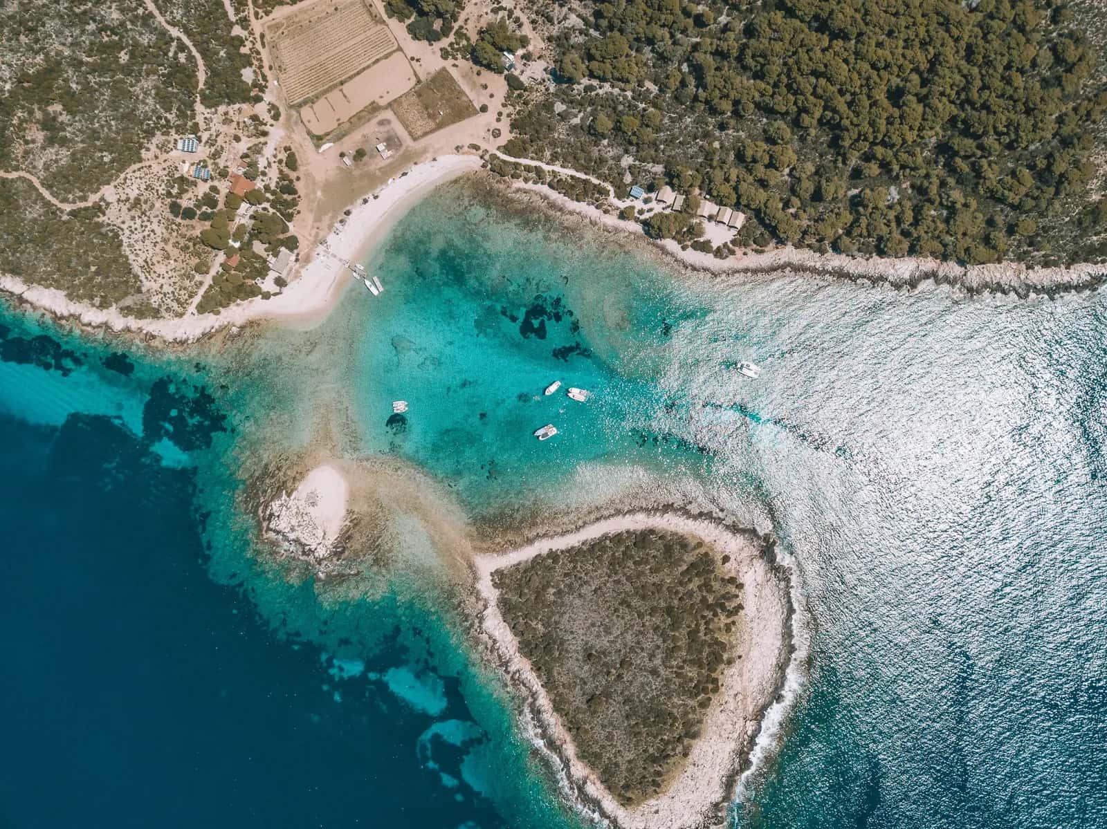 Aerial view of the Blue Lagoon near Trogir with boats anchored over turquoise shallows