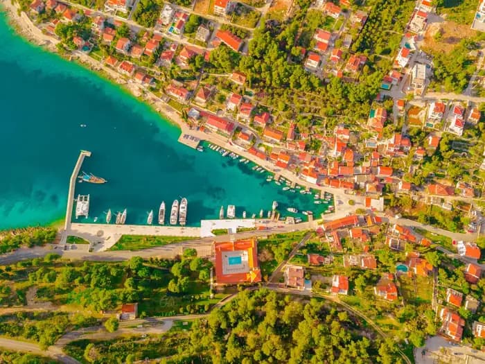 Drone view of an island beach and emerald sea