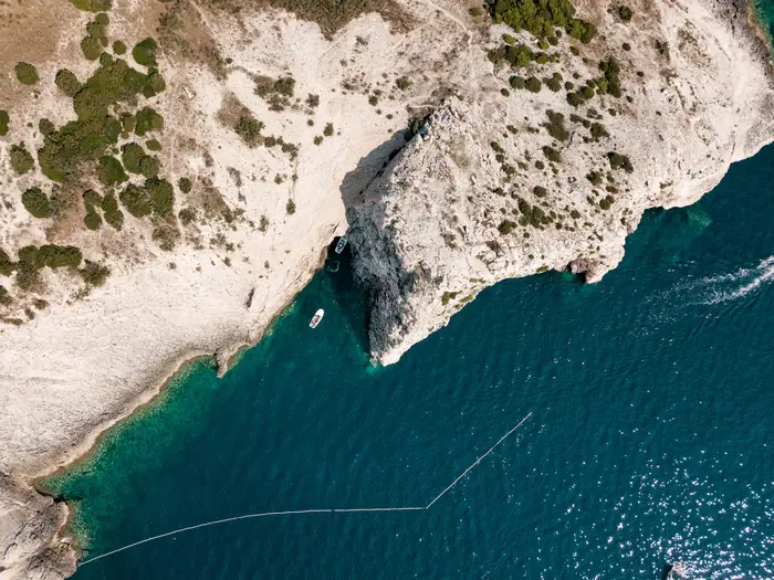 Aerial view of a secluded Adriatic cove with clear blue water