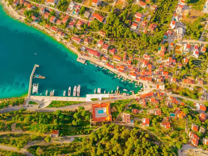 Drone view of an island beach and emerald sea