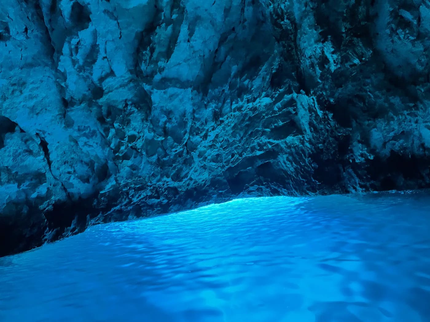 Glowing blue water deep inside the Blue Cave