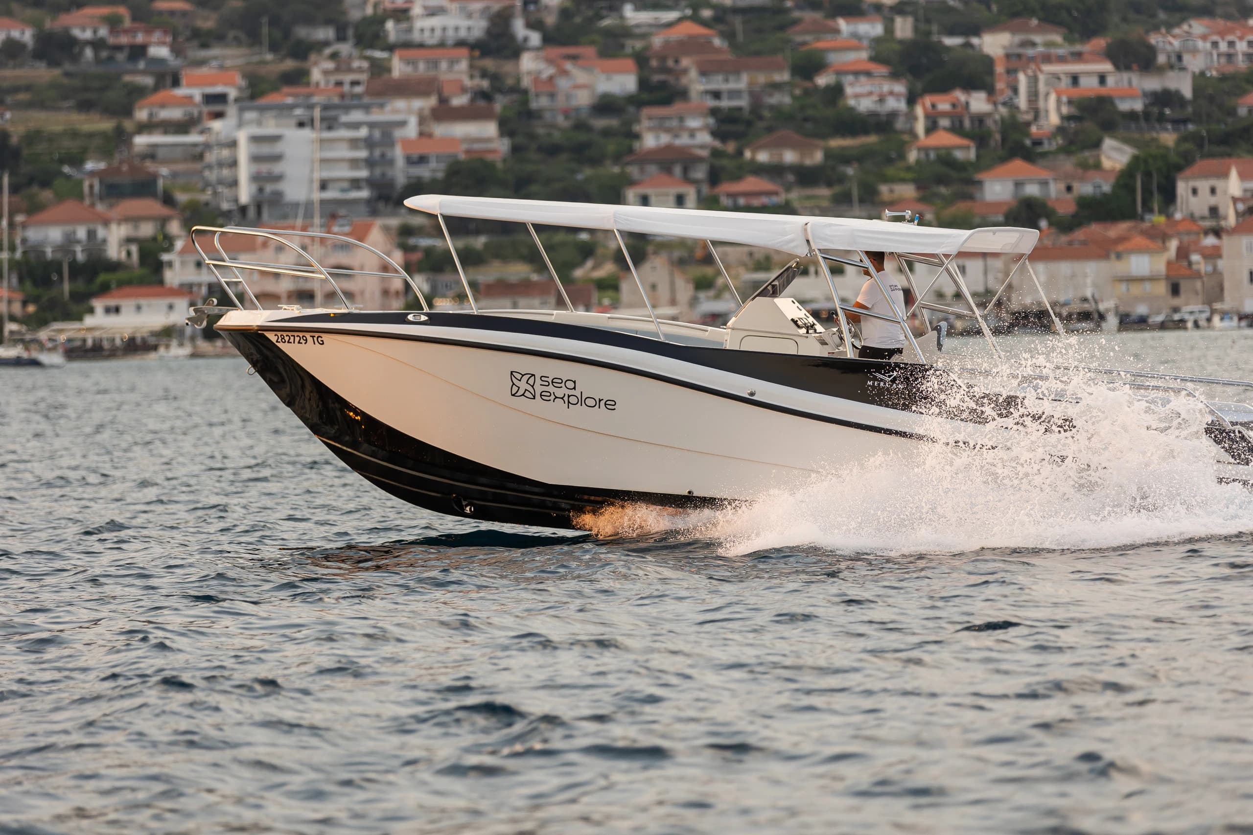 The branded SeaExplore speedboat cruising past Trogir